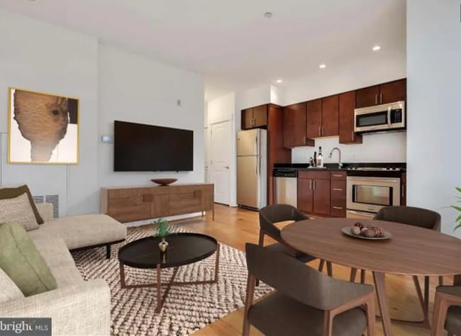 The spacious living area can easily fit a dining set, a couch, coffee table, TV, and storage. - 2910 Georgia Ave NW Apartment