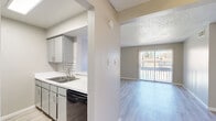 Located at 1500 Magruder St in El Paso, Texas, this single-floor, three-bedroom, one-bathroom home offers a practical and well-organized layout. Throughout the space, light wood-look flooring provides a clean, cohesive aesthetic, complemented by neutral warm-gray walls and white baseboards.

The galley-style kitchen is efficiently designed with gray cabinetry, white countertops, a classic white subway tile backsplash, and black appliances including a range, refrigerator, and dishwasher. A double stainless steel sink adds functionality to the workspace.

Adjacent to the kitchen, the living areas are bright and open. One living space features a ceiling fan with light fixture and direct access to a sliding glass door, allowing natural light to fill the room and providing a view of the outdoors. A textured ceiling adds architectural character throughout common areas.

The three bedrooms are finished consistently with the same wood-look flooring and neutral tones. The primary bedroom includes a ceiling fan, a window with outdoor views, and ample wall space. The remaining bedrooms are well-proportioned and versatile.

The bathroom is clean and straightforward, featuring a tub-shower combination, toilet, and single vanity with light wood-look flooring. Two closets provide dedicated storage within the home, enhancing overall livability.