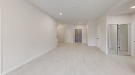 Located at 50 Otterbein Rd in Kitchener, Ontario, this thoughtfully designed 2-bedroom, 2-bathroom unit offers a clean, modern aesthetic throughout its well-proportioned single-floor layout. The open-concept living and kitchen area is anchored by light wood-look flooring and crisp white walls, creating a bright and airy atmosphere. The kitchen is equipped with stainless steel appliances — including a refrigerator, electric range, over-the-range microwave, and dishwasher — complemented by white cabinetry, grey countertops, and a subway tile backsplash. The living area flows seamlessly toward a window that invites natural light and outdoor views of the surrounding greenery. The spacious primary bedroom features a large window overlooking a landscaped exterior and includes access to a generous walk-in closet with wire shelving. Both bathrooms are finished with elegant marble-look tile flooring; one features a full vanity with under-mount sink and a bathtub, while the other offers a walk-in shower stall. A dedicated in-suite laundry room houses a full-size washer and dryer. The unit's neutral palette, recessed lighting, and consistent finishes throughout contribute to a cohesive, move-in-ready living environment.