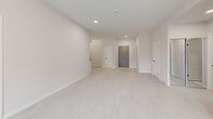 Located at 50 Otterbein Rd in Kitchener, Ontario, this thoughtfully designed 2-bedroom, 2-bathroom unit offers a clean, modern aesthetic throughout its well-proportioned single-floor layout. The open-concept living and kitchen area is anchored by light wood-look flooring and crisp white walls, creating a bright and airy atmosphere. The kitchen is equipped with stainless steel appliances — including a refrigerator, electric range, over-the-range microwave, and dishwasher — complemented by white cabinetry, grey countertops, and a subway tile backsplash. The living area flows seamlessly toward a window that invites natural light and outdoor views of the surrounding greenery. The spacious primary bedroom features a large window overlooking a landscaped exterior and includes access to a generous walk-in closet with wire shelving. Both bathrooms are finished with elegant marble-look tile flooring; one features a full vanity with under-mount sink and a bathtub, while the other offers a walk-in shower stall. A dedicated in-suite laundry room houses a full-size washer and dryer. The unit's neutral palette, recessed lighting, and consistent finishes throughout contribute to a cohesive, move-in-ready living environment.