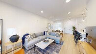 Located at 50 Kirby Ave in Somerville, NJ, this thoughtfully designed 2-bedroom, 2-bathroom residence offers a modern aesthetic with a cohesive open-concept layout. Light oak hardwood flooring flows throughout, complementing the bright white walls and recessed lighting that create a clean, airy atmosphere.

The kitchen is a standout feature, showcasing white shaker cabinetry, white quartz countertops, a classic subway tile backsplash, and a full suite of stainless steel appliances including a gas range. A peninsula with bar seating and pendant lighting connects the kitchen seamlessly to the living and dining areas, making it ideal for entertaining.

The living room is spacious and inviting, with large sliding glass doors that flood the space with natural light and provide direct outdoor access. The adjacent dining area offers a defined nook with ample natural light from nearby windows.

The generously sized primary bedroom features a ceiling fan, outdoor-facing windows, and direct access to a dedicated office space — a versatile bonus room with clean lines. Both bathrooms are well-appointed, with one featuring a dark-finish vanity paired with a black-framed mirror for a contemporary touch.

Additional highlights include ample storage with a large double-door closet, a convenient hallway, and consistent modern hardware throughout.