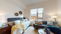 Located at 9747 NE Glisan St in Portland, Oregon, this thoughtfully designed studio unit offers a smart, efficient layout across a single floor. The open-concept living area serves as the heart of the space, combining sleeping, lounging, and dining zones seamlessly. Light-toned luxury vinyl plank flooring runs throughout, lending warmth and continuity to the interior.

A large picture window anchors the living area, filling the room with natural light and offering views of the surrounding neighborhood. The space comfortably accommodates a full-sized bed, a compact sofa, and a small dining table, making excellent use of the available footprint.

The galley-style kitchen is efficiently appointed with light maple cabinetry extending to the ceiling for ample storage, a full-size electric range, refrigerator, and a stainless steel sink with generous counter space — all finished with durable laminate countertops and complementary wood-tone flooring.

A dedicated dining nook adjacent to the kitchen provides space for seated meals, with tall ceilings adding a sense of openness. The bathroom features a full soaking tub with a tiled surround and a curtained enclosure. A ceiling fan and roller shades throughout offer practical comfort and privacy. This unit presents a clean, modern aesthetic well-suited for everyday living.