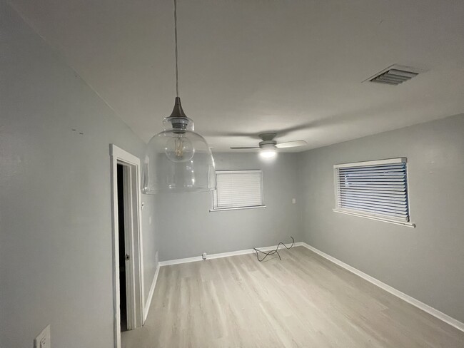 Living room with new floors, lighting, and blinds - 507 SE High School Ave