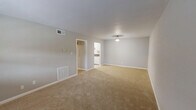 Located at 801 Gate Ln in Knoxville, Tennessee, this single-floor, three-bedroom, one-bathroom home offers a practical and comfortable layout. The living area is carpeted in warm beige tones and features neutral gray walls, a ceiling light fixture, and a large window that invites natural light. HVAC vents are conveniently positioned throughout the space for efficient climate control. The galley-style kitchen is well-appointed with white cabinetry, dark laminate countertops, a white appliance suite including an electric range, refrigerator, and dishwasher, plus a stainless steel sink. Hexagonal tile flooring and a classic tile backsplash add a clean, timeless look. The three bedrooms are carpeted and finished in soft neutral tones, each benefiting from natural light via individual windows with blinds. The spacious primary bedroom includes a dedicated closet, while additional bedrooms offer built-in closet storage with sliding or hinged doors. A hallway connects the bedrooms to the shared bathroom, which features a full tub-and-shower combo with floor-to-ceiling rectangular tile surround in a warm gray finish and brushed nickel fixtures. A dedicated closet provides additional storage. The home's straightforward, efficient design makes it a highly functional living space.