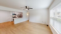 Located at 1140 W Cato Springs Rd in Fayetteville, Arkansas, this single-story 2-bedroom, 2-bathroom home offers a clean, modern aesthetic throughout. Light hardwood flooring flows seamlessly across every room, creating a bright and cohesive feel. Ceiling fans are present in the living area and both bedrooms, contributing to year-round comfort.

The open-concept living room connects directly to the kitchen via a pass-through counter, enhancing the sense of spaciousness. The kitchen is well-equipped with white shaker cabinetry, white quartz countertops, stainless steel appliances including a refrigerator, electric range, microwave, and dishwasher, plus a matte black faucet over a stainless steel sink. In-unit laundry is conveniently integrated into the kitchen space.

Both bedrooms are bright and airy, each featuring natural light from windows with views of surrounding greenery and ceiling fans with lighting. The primary bedroom includes two closet doors, offering ample storage.

The two bathrooms are identically appointed with white shaker vanities, large-format marble-look tile surrounding the tub-shower combinations, and sleek matte black fixtures, delivering a refined, contemporary look. A hallway connects the bedrooms and bathrooms, completing this efficiently designed and thoughtfully finished home.