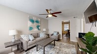 Located at 100 Lewis Dr in Millersville, TN, this single-floor, 2-bedroom, 1-bathroom residence offers a well-organized and functional layout across a compact but efficiently designed footprint. The living room serves as the welcoming heart of the home, featuring wood-style flooring, neutral warm-toned walls, a ceiling fan with light fixture, and a front-facing window that brings in natural light. The space flows naturally toward the kitchen and dining area. The kitchen is equipped with dark gray cabinetry, black appliances including a refrigerator, range, microwave, and dishwasher, along with a double-basin stainless steel sink and laminate countertops — providing ample functionality for daily cooking. The primary bedroom offers a comfortable, well-proportioned space with a ceiling fan, hardwood-style flooring, and a closet. The second bedroom, also featuring a ceiling fan and the same durable flooring, provides flexibility for use as a guest room or home office. The shared bathroom includes a vanity with a granite-style countertop, an undermount sink, gray cabinetry, and a large mirror. Throughout the residence, consistent wood-style flooring, neutral paint tones, and ceiling fans in every room contribute to a cohesive and practical living environment.