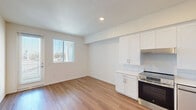 Located at 5255 Mount Etna Drive in San Diego's Clairemont Mesa neighborhood, this single-story, one-bedroom, one-bathroom unit offers a thoughtfully designed layout with a clean, modern aesthetic. Warm hardwood-style flooring runs continuously throughout, providing a cohesive and inviting feel across all rooms.

The open kitchen is a standout feature, outfitted with crisp white shaker cabinetry, light countertops, and a full suite of stainless steel appliances including a range with oven, dishwasher, and a full-size refrigerator. Recessed lighting and a range hood complete the functional yet stylish space, which flows naturally into the living area near the entry door.

The bedroom is a well-proportioned, light-filled room featuring a large window with vertical blinds that frames an outdoor view and allows ample natural light to fill the space. The neutral white walls and clean lines create a calm, versatile environment.

The bathroom is designed with accessibility in mind, featuring grab bars near the toilet and along the wall, a white vanity with under-sink storage, a large mirror, and a clean, open layout. The same hardwood-style flooring carries through, maintaining visual continuity.

Two hallways connect the rooms efficiently, contributing to the unit's smart, functional flow throughout.