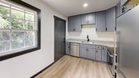 Located at 2436 Belvedere Ave in Knoxville, TN, this thoughtfully updated single-story home offers two bedrooms, two bathrooms, and a well-appointed layout that maximizes every square foot. Consistent light wood laminate flooring and crisp white walls run throughout, unified by bold dark baseboards and gray-toned interior doors that give the home a clean, contemporary aesthetic.

The kitchen is a standout feature, showcasing slate-gray shaker cabinets, light granite countertops, a stainless steel dishwasher, and a modern black-finish faucet — all complemented by a window that brings in natural light. The living room offers recessed lighting alongside a decorative flush-mount fixture and a wall-mounted mini-split HVAC unit for efficient climate control.

The primary bedroom is generously sized, featuring a window with outdoor views and its own dedicated closet. The secondary bedroom also includes a window with natural light and dedicated closet access. Three closets total serve the home's storage needs. Both bathrooms are finished with clean white vanities, black-framed mirrors, and matte black fixtures. One bathroom features a tub/shower combination with striking marble-style wall surrounds and a built-in niche. A connecting hallway ties all rooms together efficiently.