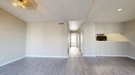 Located at 13658 O'Connor Rd in San Antonio, Texas, this single-story 2-bedroom, 1-bathroom home offers a clean, modern aesthetic throughout its thoughtfully designed floor plan. The living area welcomes you with vaulted ceilings, a stylish light fixture, and large windows fitted with blinds that allow abundant natural light to fill the space. Light gray wood-look flooring runs through the main living areas, lending a cohesive and contemporary feel.

The layout includes multiple living spaces connected by a central hallway, along with a pantry and a dedicated utility room for added convenience. The kitchen features a pass-through opening to the living area, enhancing the open feel of the home.

Both bedrooms are carpeted and well-lit by natural light through windows. The primary bedroom is generously sized and includes a closet, while the second bedroom also offers a closet with built-in wire shelving. Additional closets provide ample storage throughout the home.

The bathroom is finished with tile flooring, a slate-blue vanity topped with a marble-look countertop, and a full tub-shower combination. Neutral gray tones are carried throughout every room, creating a calm and cohesive ambiance that makes the home feel bright and move-in ready.
