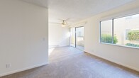 Located at 6165 Cottle Road in San Jose, CA, this single-story residence offers a practical and comfortable layout across three bedrooms and two bathrooms. The living room is bright and welcoming, featuring plush carpet, a ceiling fan, a baseboard heating unit, and large sliding glass doors that open to outdoor greenery views, allowing natural light to fill the space. An additional window further enhances the airy feel of the room.

The kitchen is efficiently designed with ample white cabinetry both above and below the countertops, light wood-style flooring, and generous counter space, providing plenty of room for meal preparation and storage.

Each bedroom is carpeted and includes a sliding-door closet for storage. One bedroom benefits from a large window framing lush outdoor greenery, while the primary bedroom offers a comfortable footprint with its own closet and easy hallway access.

The two bathrooms are clean and functional. One features wood-style flooring, a single-sink vanity with white cabinetry, and a glass-enclosed shower stall. The second bathroom mirrors the same flooring and vanity style, with a shower-tub combination. Both bathrooms are finished with neutral tones and simple, understated fixtures throughout. A connecting hallway ties all rooms together in a cohesive, easy-to-navigate floor plan.