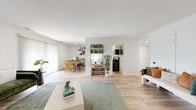 Located at 8818 Blairwood Rd in Nottingham, MD, this single-floor, one-bedroom, one-bathroom home offers a clean, modern aesthetic throughout its well-utilized layout. Light wood flooring flows seamlessly across the main living areas, creating a warm and cohesive feel.

The open-concept living and dining area is bright and airy, with white walls and large windows allowing natural light to fill the space. The living room features a distinctive black-framed glass partition wall, adding a contemporary architectural touch. The dining area, adjacent to the kitchen, comfortably accommodates a full dining set and is accented by bold botanical artwork.

The kitchen is outfitted with white cabinetry, white countertops, stainless steel appliances including a refrigerator and dishwasher, and an electric range. Open shelving along one wall provides additional storage and display space.

The bedroom is a comfortable retreat with plush carpeting, crisp white walls, and a sliding-door closet offering ample storage. The bathroom features gray subway tile surrounding the tub-shower combination, a white vanity, and wood-look flooring, blending classic and contemporary design elements.

A hallway connects the rooms efficiently, completing this functional and stylish single-floor home.