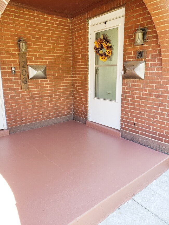 Welcoming porch with Ring doorbell, mailbox, and single-step entry. - 201 Richbarn Rd