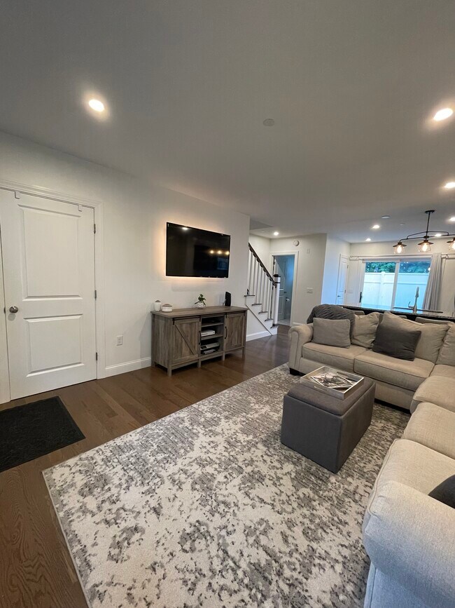 Wall mounted flatscreen tv and large sectional couch with ottoman - 54 Seavey St