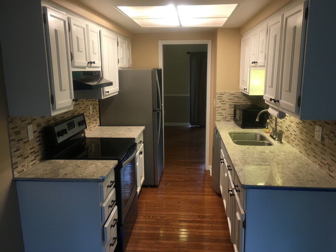 Updated kitchen with new granite countertops and brand new stainless steel appliances. - 1403 Oakbrook East Drive
