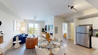 Located at 3300 Boutwell Rd in Lake Worth Beach, Florida, this well-designed one-bedroom, one-bathroom residence offers a thoughtfully arranged open-concept floor plan across a single level. Light-toned luxury vinyl plank flooring flows throughout the main living areas, complementing the clean, modern aesthetic of the space.

The combined kitchen, dining, and living area serves as the heart of the home. The kitchen features white flat-front cabinetry, stainless steel appliances, a textured tile backsplash, and dark countertops, all illuminated by track lighting. A glass-top dining table anchors the eat-in area, which transitions naturally into the living room. The living space benefits from abundant natural light and direct access to a private balcony through sliding glass doors, offering views of the surrounding community.

The bedroom is a comfortable retreat with plush carpeting, a ceiling fan, and a window that brings in natural light and outdoor views. A closet provides practical storage within the room. The bathroom is finished in a crisp, all-white palette and features a glass-enclosed walk-in shower with mosaic tile flooring and matte black hardware accents, lending a modern and clean aesthetic. This residence combines functional layout with contemporary finishes in a prime South Florida location.