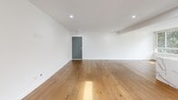 Located at 1267 N Laurel Ave in the heart of West Hollywood, this thoughtfully designed 2-bedroom, 1-bathroom residence offers a clean, modern aesthetic across a single floor. Wide-plank hardwood floors run throughout the entire space, lending warmth and continuity to every room.

The open-concept kitchen and living area serves as the centerpiece of the home. The chef's kitchen is outfitted with a large marble-topped island featuring a gas cooktop and integrated wine storage, sleek white cabinetry with warm wood accents, stainless steel appliances including a built-in refrigerator and wall oven, and a marble tile backsplash. A skylight and multiple windows bathe the kitchen in natural light, with views of surrounding greenery.

The spacious living room features recessed lighting, crisp white walls, and large windows that frame tree-lined views, creating a bright and airy atmosphere. Both bedrooms are well-proportioned, with the primary bedroom offering generous closet space behind full-length mirrored sliding doors and large windows overlooking lush foliage. The bathroom is finished with large-format marble tile flooring, a floating wood-accented vanity, and chrome fixtures, maintaining the home's refined, contemporary style throughout.
