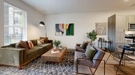 Located at 2490 Cobb Pkwy SE in Atlanta, GA, this one-bedroom, one-bathroom residence offers a thoughtfully designed layout that maximizes every square foot. Light wood-tone flooring flows throughout, creating a cohesive and airy feel across all rooms.

The open-concept living and dining area provides a comfortable, versatile space for both relaxing and entertaining. The living room features clean white walls that serve as a canvas for bold, colorful artwork, complemented by mid-century modern furnishings and a patterned area rug that adds warmth and texture.

The kitchen is a standout feature, outfitted with light wood cabinetry, white quartz countertops, stainless steel appliances, and a matte black faucet. A central island with bar seating doubles as a dining and prep area, making the kitchen both functional and stylish. Open shelving adds a modern, accessible touch.

The bedroom is a serene retreat, bathed in natural light from large windows that offer outdoor views. Soft, neutral tones and wood accents create a calming atmosphere, while a dedicated closet provides ample storage.

The bathroom is clean and modern, featuring light cabinetry with dark hardware, a full tub-shower combo, and a sage green accent wall that adds a refreshing pop of color. A dedicated nook near the dining area offers space for a home office setup.