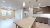 Located at 591 Carlson Ave in Rohnert Park, CA, this well-appointed single-floor home offers a thoughtfully designed layout with 1 bedroom and 2 full bathrooms. The open-concept kitchen and living area serves as the heart of the home, featuring rich wood-grain cabinetry, a white subway tile backsplash, quartz countertops, a generous kitchen island with pendant lighting, and a full suite of stainless steel appliances including a refrigerator, range, microwave, and dishwasher. Light wood-style flooring flows throughout the main living areas, enhancing the bright, airy atmosphere created by recessed lighting throughout. The spacious bedroom is finished with plush carpeting, a ceiling fan, and windows that invite natural light. A walk-in closet with built-in shelving and hanging rods provides ample storage. Both bathrooms are finished with warm wood-tone vanities, quartz countertops, and light wood-style flooring. One bathroom features a tub-shower combination with classic subway tile surround, while the other offers a sleek vanity with a large mirror. The hallway connects all areas efficiently, and a dedicated entrance completes this clean, modern residence.