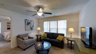 The Starmount with Sunroom is a single-story, 2-bedroom, 2-bathroom residence designed to provide comfortable and practical living spaces. The floor plan makes efficient use of its square footage, incorporating a bonus sunroom that adds versatile living space and an abundance of natural light to the home.

The living room serves as a central gathering area, featuring plush carpeted flooring and a textured ceiling accented by a ceiling fan with integrated lighting. A large multi-pane window dressed with horizontal blinds allows natural light to fill the room, creating a bright and welcoming atmosphere. The neutral wall tones provide a flexible backdrop for a variety of furnishing styles.

The sunroom is a notable highlight of this floor plan, offering additional living space that can serve as a reading nook, home office, or relaxation area, and is ideal for enjoying natural light year-round.

The two bedrooms provide private retreats, while the two full bathrooms ensure convenience for residents and guests alike. The overall layout of the Starmount with Sunroom balances open communal areas with private spaces, making it a well-rounded and functional residence suited for a range of lifestyles.