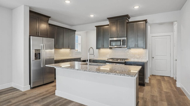 Kitchen with Stainless Steel Appliances - The Louise Townhomes