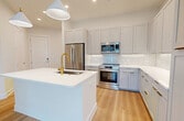 This single-story residence at 5301 W Tyson Ave, Tampa FL 33611, offers 1360 square feet of thoughtfully designed living space. The home features three bedrooms, including a spacious primary bedroom of 170 square feet, and two full bathrooms. The open-concept floor plan seamlessly integrates the kitchen and living room, creating an ideal space for both everyday living and entertaining.

Throughout the home, light wood flooring adds warmth and continuity, while large windows with white blinds allow for abundant natural light and privacy control. The kitchen boasts sleek white cabinetry with modern hardware, complemented by a subway tile backsplash and quartz countertops. Stainless steel appliances complete the contemporary aesthetic.

The bathrooms are elegantly appointed with floating vanities, large mirrors, and glass-enclosed showers. The home's storage solutions are impressive, with multiple closets featuring built-in shelving and hanging space. A dedicated laundry room with modern front-loading appliances adds convenience to daily life.

The neutral color palette and clean lines throughout create a fresh, modern ambiance that serves as a perfect canvas for personal style. This well-designed home offers a harmonious blend of functionality and contemporary aesthetics, making it an ideal choice for those seeking a comfortable and stylish living environment in Tampa.