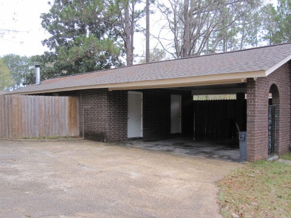 Double car carport with storage and game room to left - 607 Cox Ave