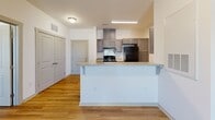 Located at 119 Future Way in Statesville, NC, this single-floor, 2-bedroom, 1-bathroom residence offers a practical and well-designed layout. Wood-style flooring runs throughout the entire home, creating a cohesive and easy-to-maintain aesthetic.

The open-concept kitchen and living area form the heart of the home. The kitchen is equipped with dark gray shaker-style cabinetry, light stone-look countertops, black appliances including a range and refrigerator, a double stainless steel sink, and a breakfast bar peninsula that provides additional seating and separates the kitchen from the living area. The living room benefits from natural light through a front-facing window and is topped with a ceiling fan for added comfort.

Both bedrooms feature wood-style flooring, clean white walls, and panel-style doors. The primary bedroom includes a ceiling fan with a window that allows natural light to fill the room. A dedicated walk-in closet with built-in wire shelving and hanging rods provides generous storage.

The bathroom is clean and functional, featuring a full-size soaking tub with a shower and chrome fixtures. The neutral white finish gives the space a crisp, bright feel. This home offers an efficient, move-in-ready layout suited for comfortable everyday living.