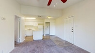 Located at 3631 Callaghan Road in San Antonio, TX, this single-level, one-bedroom, one-bathroom unit offers a practical and comfortable layout. The open-concept living and kitchen area is anchored by wood-look flooring and transitions seamlessly into plush carpeting in the living space. Vaulted ceilings with a ceiling fan add a sense of height and airiness throughout. The kitchen is well-appointed with white cabinetry extending to the upper walls, a full suite of white appliances including a refrigerator, dishwasher, and range, as well as a central island featuring a marble-look countertop that provides additional workspace and casual seating. A textured ceiling and recessed lighting complete the kitchen's clean, bright aesthetic. The bedroom features vaulted ceilings, soft carpeting, a ceiling fan, a natural light-filled window with blinds, and direct access to both the bathroom and a dedicated closet. The bathroom is efficiently designed with a full tub-shower combination, a vanity with storage, overhead cabinetry, and wood-look flooring. A sliding glass door in the living area provides access to the outdoors. This unit offers a cohesive, functional design well-suited for comfortable everyday living.