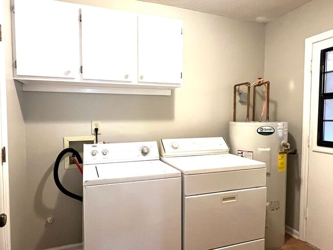 Washer and dryer in the separate laundry room in the unit - 902 Penn Waller Rd