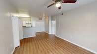 Located at 1702 Skinner St in Freeport, TX, this single-story, one-bedroom, one-bathroom home offers a practical and well-organized layout. The combined kitchen and living area forms the heart of the home, with warm-toned luxury vinyl plank flooring running throughout. A ceiling fan with integrated lighting adds comfort to the living space, while a large window invites natural light and outdoor views, creating a bright and welcoming atmosphere.

The kitchen is efficiently designed with ample white cabinetry accented by wood-toned trim, a granite-style countertop, and a peninsula that provides additional workspace and storage. White appliances, including a range, refrigerator, microwave, and dishwasher, complete the functional setup.

The bedroom is a comfortable retreat featuring plush carpeting, a ceiling fan, and a generously sized window that frames views of the surrounding greenery. A dedicated closet provides practical storage.

The bathroom is thoughtfully equipped with accessibility features, including grab bars near the toilet and shower area. It features a vanity with a sink, a large mirror, and matching vinyl plank flooring. A hallway connects the rooms, contributing to a cohesive and easy-to-navigate floor plan. The overall aesthetic is clean, neutral, and move-in ready.