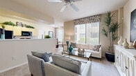 Located in Phoenix, AZ, this single-floor residence offers four bedrooms and two bathrooms within a well-designed, efficient layout. The open-concept living area welcomes you with warm neutral tones, plush carpeting, and a ceiling fan overhead. Large windows dressed with decorative valances and vertical blinds allow abundant natural light to fill the space while framing views of the surrounding greenery.

The kitchen features light wood cabinetry, dark granite-style countertops, and black appliances, flowing seamlessly into a dedicated dining area with wood-style flooring and natural light from a broad window. A separate dining room provides additional space for gatherings.

The primary bedroom is a comfortable retreat with soft carpeting and room for full-sized furnishings, while the additional bedrooms are equally well-proportioned, each featuring windows that bring in natural light. The bathrooms are finished with light wood vanity cabinetry, dark countertops, large mirrors with overhead lighting, and a combination tub and shower.

A hallway connects the living areas to the private quarters, and a dedicated closet offers practical storage. The entry foyer transitions from wood-style flooring to carpeting, establishing a clean boundary between the home's living zones. The overall ambiance is warm, bright, and functional throughout.