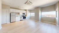 Located at 6445 America Blvd in Hyattsville, MD, this well-designed one-bedroom, one-bathroom unit offers a functional and modern living experience across a single floor. The open-concept layout seamlessly connects the living, dining, and kitchen areas, creating a bright and spacious feel. The kitchen is equipped with stainless steel appliances, including a refrigerator, range, microwave, and dishwasher, complemented by sleek white cabinetry and a clean, contemporary aesthetic. Light hardwood flooring extends throughout the main living areas, enhancing the sense of openness and warmth, while large windows invite natural light and provide views of the surrounding area. A dedicated hallway connects the main living space to the private areas of the unit. The bedroom features soft carpet flooring and includes a closet with louvered doors, offering practical storage. In total, three closets are spread throughout the unit, providing generous storage options. The bathroom is finished with large-format tile flooring, a white vanity with a clean countertop, and an illuminated mirror, lending a crisp, modern feel. An in-unit laundry area adds everyday convenience. The neutral color palette and clean lines throughout create a cohesive, move-in-ready environment.