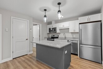 Efficient kitchen with full appliance package, granite island, and ample storage. - The Parker