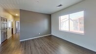 This 1,050-square-foot, single-story apartment at 3147 Willow Creek Rd in Prescott, AZ offers 2 bedrooms and 2 bathrooms across a well-planned layout. The open kitchen-living area features wood-look vinyl flooring, dark espresso cabinetry, granite countertops, stainless steel appliances, and a dedicated pantry with built-in shelving. Natural light flows through blinds-equipped windows overlooking the surrounding neighborhood. The primary bedroom spans 180 square feet and includes wood-look flooring, a neutral accent wall, and a window. Its en-suite bathroom features a dual-sink vanity with granite countertops, dark cabinetry, modern light fixtures, dual mirrors, and wood-look flooring. A spacious walk-in closet with wrap-around wooden rods and carpet completes the primary suite. The second bedroom offers plush carpet, a ceiling fan, and two windows for abundant natural light. The second bathroom mirrors the primary bath's finishes with a dual-sink granite vanity and dark cabinetry. Throughout the unit, clean white walls, consistent flooring choices, and modern fixtures create a cohesive, move-in-ready aesthetic suited for comfortable living in Prescott.