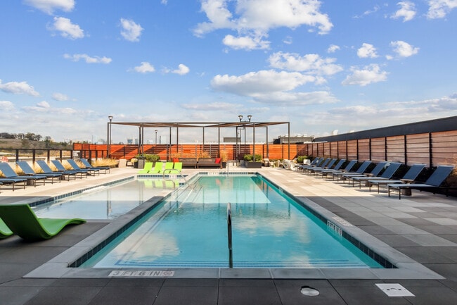 Soak up the sun and skyline views at our rooftop oasis. - Residences at The Finery