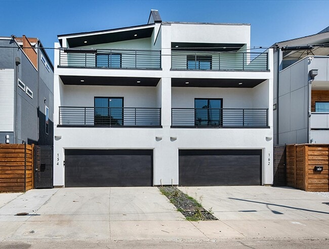Modern Munger Place townhome with city sky...