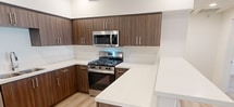 This contemporary 790 square foot apartment in Murrieta, CA offers a harmonious blend of style and functionality. The open-concept design maximizes the use of space, creating a seamless flow between the living areas. The kitchen is a standout feature, boasting rich wood cabinetry, stainless steel appliances, and a convenient breakfast bar. Both bathrooms are elegantly appointed with modern fixtures, including wood vanities and large mirrors. The bedrooms are generously sized, with the primary bedroom spanning an impressive 220 square feet. Throughout the apartment, light wood flooring adds warmth and continuity. Large windows in the living areas and bedrooms allow for ample natural light, while recessed lighting provides a modern touch. The property also includes a private outdoor space, perfect for relaxation or entertaining. With its thoughtful design and high-quality finishes, this apartment offers a comfortable and stylish living experience in a prime Murrieta location.