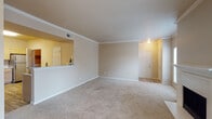 Located at 1150 Hidden Ridge in Irving, TX, this single-floor residence offers a well-designed layout with a blend of comfort and functionality. The expansive living room is anchored by a classic fireplace and adorned with elegant crown molding, with natural light streaming in through large windows fitted with blinds. Plush carpeting flows throughout the living and bedroom areas, lending a warm, inviting atmosphere.

The open-concept kitchen connects seamlessly to the living space via a pass-through bar counter, and features light wood cabinetry, stainless steel appliances including a refrigerator, range, and microwave, light-toned countertops, and wood-look flooring. A dedicated in-unit laundry area is conveniently accessible from the kitchen.

The bedrooms are generously sized, each with plush carpet, ample closet space, and ceiling fans for added comfort. Natural light fills the rooms through well-placed windows with outdoor views.

The primary bathroom is a standout feature, offering dual vanities with light wood cabinetry, a large corner soaking tub, a separate walk-in shower, and wood-look flooring. A secondary bathroom provides a tub-shower combination with a single vanity. Throughout the space, neutral tones and thoughtful finishes create a cohesive and comfortable living environment.