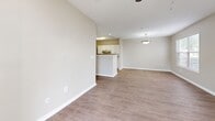 Located on Cottage Hill Road in Mobile, Alabama, this single-story, one-bedroom, one-bathroom unit offers a well-organized layout across a comfortable footprint. The galley-style kitchen is outfitted with white shaker cabinetry, light stone countertops, stainless steel appliances including a refrigerator, dishwasher, and range, and wood-look vinyl plank flooring that extends throughout the main living areas. A peninsula counter separates the kitchen from the adjoining living room, which features a pendant light fixture and a window that allows natural light to fill the space.

The bedroom is carpeted for comfort and includes a ceiling fan, a window with exterior views, and sufficient wall space for furnishings. Neutral, warm-toned walls are consistent throughout the unit, contributing to a cohesive and calm ambiance. The bathroom is equipped with a tub-shower combination featuring white tile surround, grab bars, and a vanity with stone countertop. A dedicated laundry area includes washer and dryer hookups, offering added convenience. A closet provides additional storage within the unit.