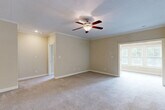 Located at 3150 Skinner Mill Rd in Augusta, Georgia, this single-story home offers a practical and comfortable layout with three bedrooms, five bathrooms, a bonus room, and a dedicated laundry room. The interior is finished with neutral warm-toned walls, plush carpeting throughout the main living areas, and tile flooring in the kitchen and wet areas.

The kitchen is well-equipped with rich dark wood cabinetry, granite-style countertops, stainless steel appliances including a range and built-in microwave, and a breakfast bar with pendant lighting. It flows naturally into a carpeted dining area illuminated by a chandelier, creating an inviting space for everyday meals.

The living room is open and airy, while the generously sized primary bedroom features crown molding, a ceiling fan with light fixture, natural light from a double window, and access to a private ensuite with a soaking tub. Additional bedrooms are well-proportioned with ample closet access — the home includes seven closets in total. The five bathrooms provide excellent convenience for residents and guests alike.

The laundry room is outfitted with tile flooring, upper cabinetry for storage, and dedicated hookups. A bonus room adds versatile space for a home office, playroom, or flex use. The home's cohesive design and functional floor plan make it a well-rounded residence.