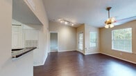 This well-designed 550 square foot one-bedroom apartment offers a harmonious blend of comfort and functionality. The space is thoughtfully laid out, maximizing every inch of its single-floor plan. Upon entry, you're greeted by a combined kitchen and living area, featuring warm wood-toned flooring that extends throughout most of the apartment.

The kitchen is equipped with light wood cabinetry, stainless steel appliances, and a convenient breakfast bar with granite countertops. The living area is bathed in natural light from large windows, creating an open and airy feel. A sliding glass door leads to a private balcony, perfect for enjoying outdoor views.

The spacious 150 square foot bedroom boasts plush carpeting and ample closet space. The full bathroom is modern and pristine, with a shower-tub combination and clean white fixtures. Throughout the apartment, neutral wall colors provide a blank canvas for personalization.

Additional features include a ceiling fan for improved air circulation, window blinds for privacy, and strategically placed lighting fixtures. This apartment efficiently utilizes its space, offering a comfortable and stylish living environment in a compact footprint.
