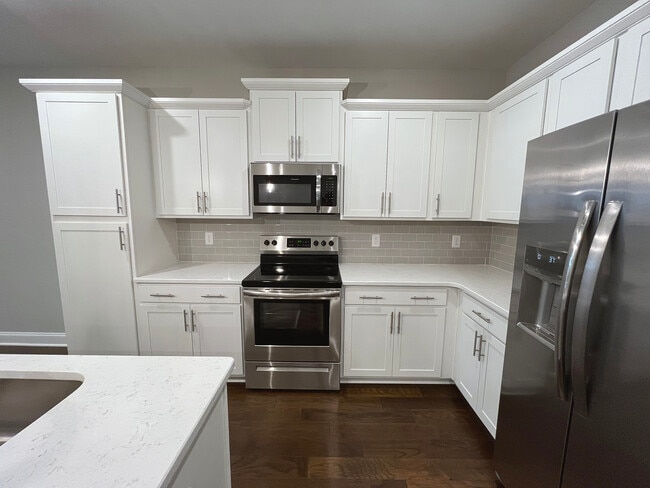 Cabinet area with Stove, Microwave and Fridge - 4000 Shadow Green Dr