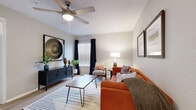 This one-bedroom, one-bathroom residence in Temple Terrace, Florida offers an efficient, well-designed layout across a single floor. Light wood-style flooring runs throughout the main living areas, creating a bright and cohesive aesthetic. The living room is an inviting space, featuring a ceiling fan, neutral-toned walls, and a window dressed with blinds and dark grommet curtains that allow for flexible light control. Clean white baseboards and framed wall art contribute to a polished, contemporary feel.

The kitchen is compact yet functional, equipped with stainless steel appliances including a refrigerator, electric range, and over-the-range microwave. White shaker-style cabinetry and light countertops provide a crisp, modern look, complemented by a tile backsplash.

The generously sized primary bedroom features plush carpeting, a ceiling fan, a window with natural light, and a mirrored sliding-door closet offering ample storage. The bathroom includes a tub-shower combination with marble-style tile surround, a white vanity with under-cabinet storage, a large mirror, and wood-style flooring for easy maintenance. Overall, the space maintains a clean, modern character throughout.