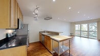 Located at 4421 Gilbert St in Oakland's vibrant 94611 neighborhood, this one-bedroom, one-bathroom residence offers a well-designed, efficiently laid-out single-floor plan. Rich hardwood floors run throughout, lending warmth and continuity to every room.

The kitchen is a standout feature, outfitted with stainless steel appliances — including a range, microwave, and refrigerator — complemented by warm wood cabinetry, dark granite countertops, and a peninsula with a granite surface. Track lighting and a suspended pot rack above add both functionality and character to the space.

The living room is bright and open, with recessed lighting and a full-width sliding glass door that opens to a private balcony overlooking mature trees and the surrounding neighborhood, filling the room with natural light.

The bedroom is comfortably sized, featuring a window with views of the tree-lined surroundings, recessed lighting, hardwood flooring, and a dedicated closet. The bathroom includes a full soaking tub and shower combination with clean, light-toned wall surrounds.

A hallway connects the rooms, completing the functional layout. This residence combines practical design with inviting finishes in a well-established Oakland location.