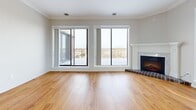 Located at 161 Nelson St in Sarnia, Ontario, this well-appointed 2-bedroom, 1-bathroom unit offers a thoughtfully designed single-floor layout with generous living space. The open living room is a standout feature, showcasing warm hardwood flooring, crown moulding, large sliding glass doors, and a classic fireplace — all framing sweeping outdoor views that flood the room with natural light. The kitchen is fully equipped with white shaker-style cabinetry, light stone countertops, a white subway tile backsplash, and a full suite of stainless steel appliances including a range, over-the-range microwave, and dishwasher. Light tile flooring completes the kitchen's clean, functional aesthetic. The spacious primary bedroom continues the hardwood flooring theme and features sliding glass doors opening to a balcony with panoramic views, alongside a built-in closet with bi-fold doors. The bathroom is finished with tile flooring, a single vanity with stone countertop, and a glass-enclosed shower. A dedicated laundry area includes a full-size washer and dryer, a utility sink, and ample upper cabinetry for storage. Additional storage is provided by a shelved walk-in pantry or storage room with tile flooring.