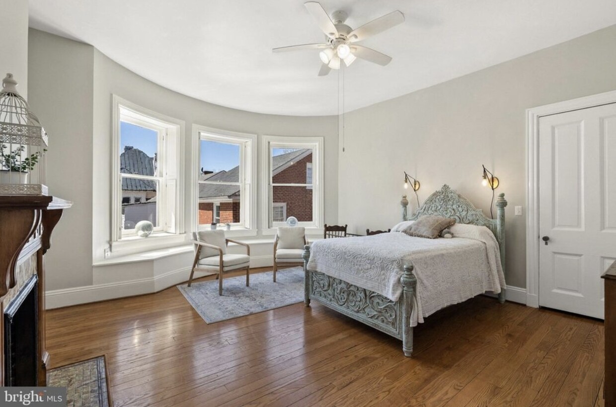 Primary Bedroom upstairs facing south. With shutters. - 121 W Cork St