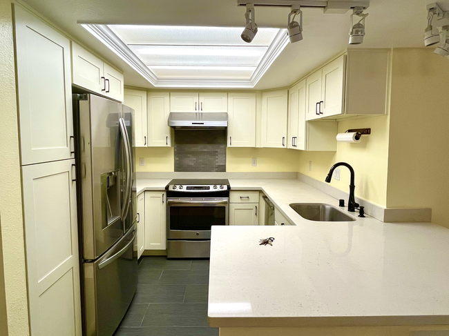 Kitchen with new fridge and stove - 1296 Bellevue Way NE