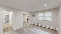 Located at 1314 Wharton Dr in Newark, Delaware, this single-story home offers four bedrooms, two bathrooms, two living areas, and a dedicated kitchen — all unified by a clean, neutral aesthetic and light wood-tone flooring throughout. The layout flows efficiently through a central hallway connecting all rooms.

The kitchen is a standout feature, equipped with light wood cabinetry, granite countertops, a white subway tile backsplash, and stainless steel appliances including a refrigerator, electric range, and dishwasher. Natural light enters through a window fitted with blinds, brightening the functional workspace.

The bedrooms are bright and simply designed, each featuring neutral walls, recessed lighting, and windows with blinds that allow ample natural light. The generously sized primary bedroom includes a wall-mounted air conditioning unit and baseboard heating. The remaining bedrooms offer similarly comfortable layouts with windows and baseboard heating.

The two bathrooms are finished in a clean, modern style. One features a white vanity with under-cabinet storage, a framed mirror, and a window. The second includes a tiled tub-shower combination with a clean white finish. Both bathrooms continue the light flooring found throughout the home.

The two living areas provide flexible space, each open and airy with recessed lighting and baseboard heating.