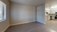 This 570 square foot apartment in Phoenix, AZ offers a thoughtful layout maximizing space efficiency. The single-floor design includes a combined kitchen and living room, one bedroom, one bathroom, a closet, and a hallway. The kitchen boasts modern white cabinetry, granite countertops, and stainless steel appliances, including a refrigerator, stove, and built-in microwave. The living area, with its light wood-look flooring, provides ample space for relaxation and entertaining. The bedroom, measuring 150 square feet, features a window for natural light and the same attractive flooring. The bathroom showcases a contemporary design with a white tub-shower combination and a sleek vanity. Throughout the apartment, neutral wall colors and modern lighting fixtures create a bright, welcoming atmosphere. The property's location at 3434 E McDowell Rd in Phoenix offers urban convenience in a refreshed living space.