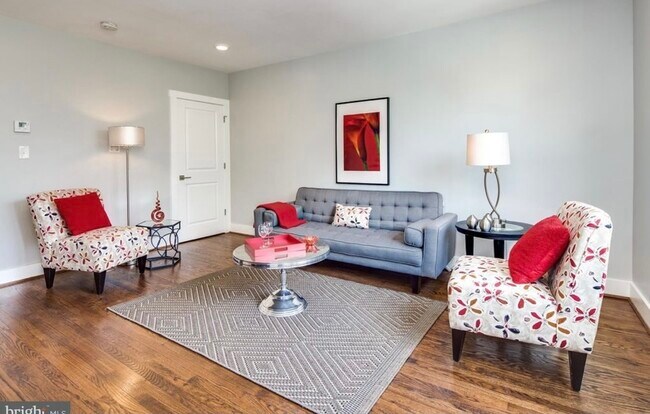 Light filled living room. Original hardwood floors and recessed lighting. - 4000 8th St NE